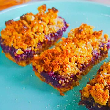 Jam crumb bars slices served on a plate.