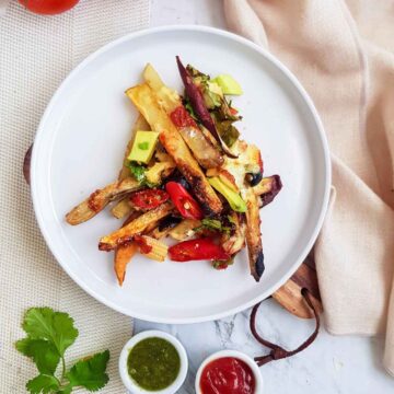 vegan loaded fries served on a white plate.