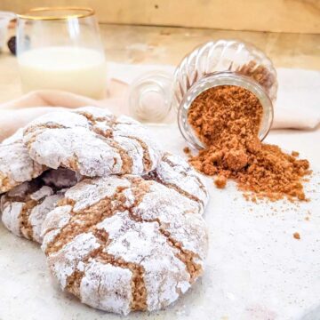 Stack of soft almond cookies on a white background.