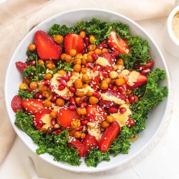 Vegan Kale Salad topped with chickpeas and tahini dressing