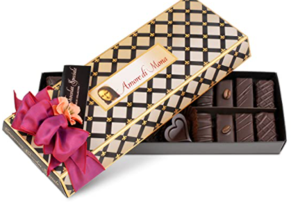 golden box of vegan chocolates with pink ribbon on top