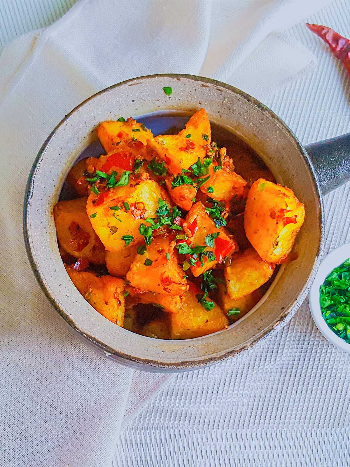 Batata Harrah served in a Bowl topped with cilantro and chilies