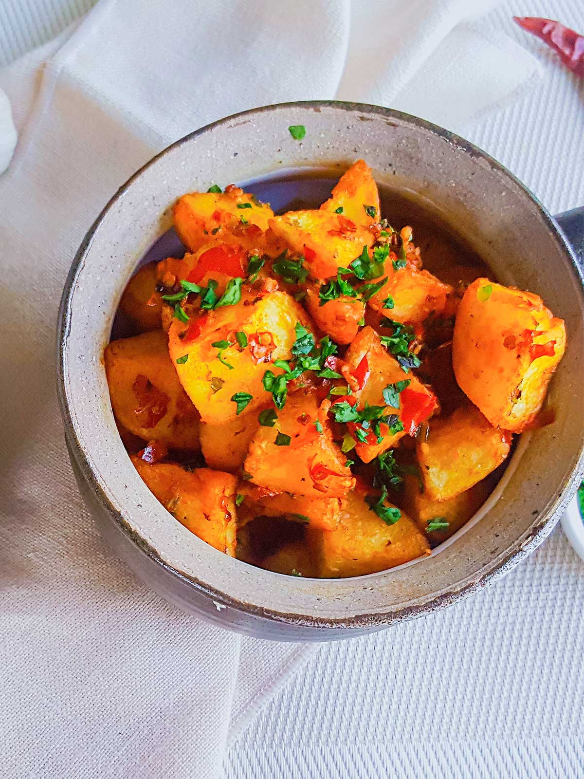 Batata Harrah served in a Bowl topped with cilantro and chilies