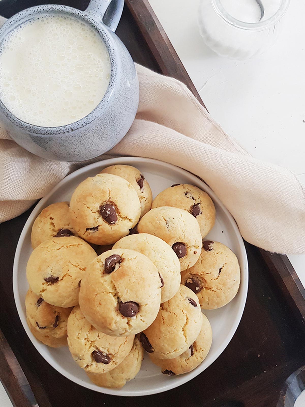 Eggless chocolate chip cookies served in a plate with oat milk cup