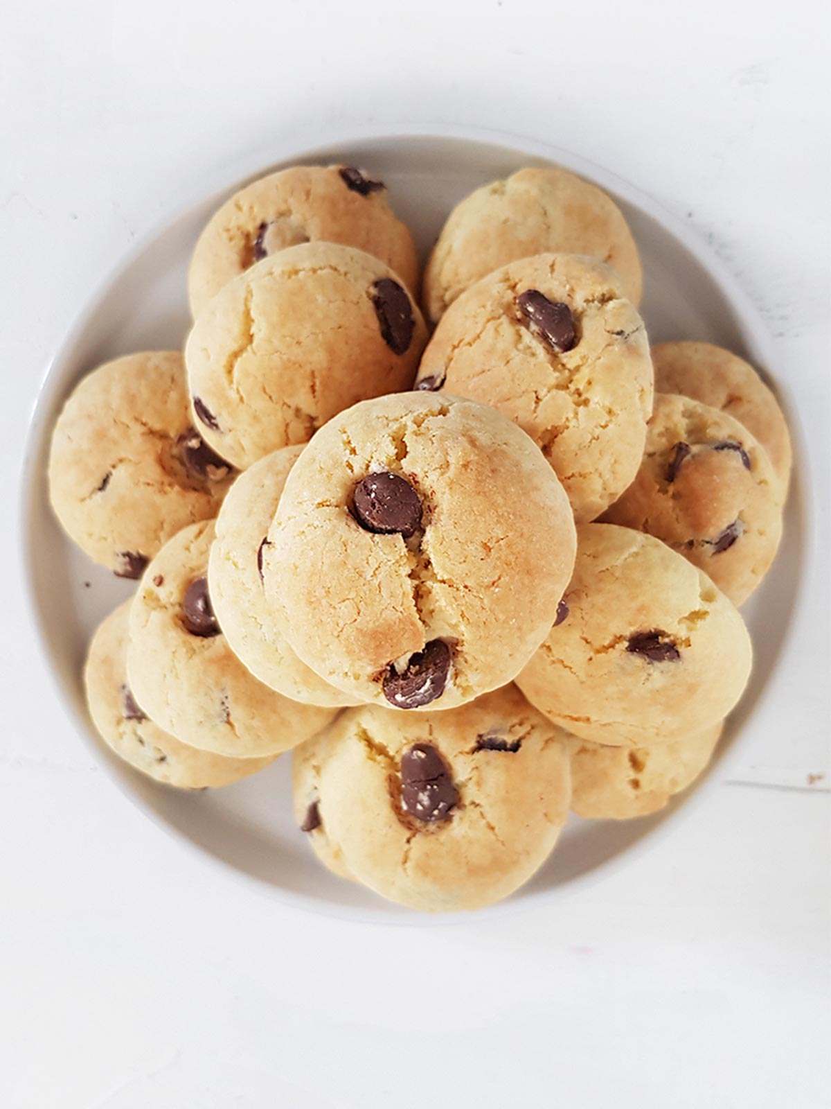 Eggless chocolate chip cookies pile in a plate