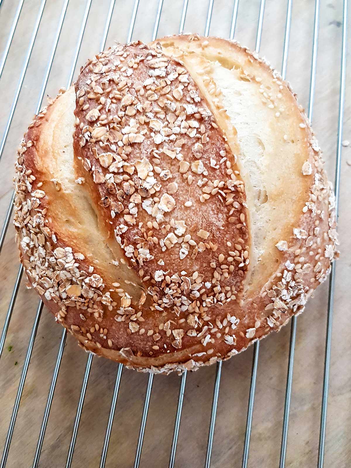 bread loaf cooling on steel rack