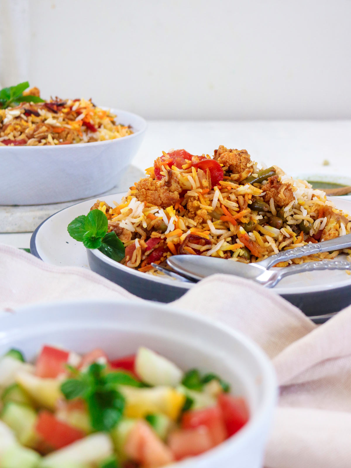vegan biryani served in a plate with spoon and fork