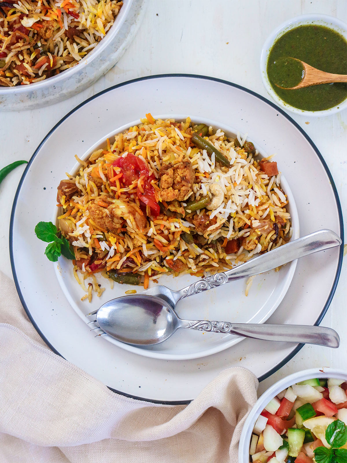 vegan biryani served in a plate with spoon and fork