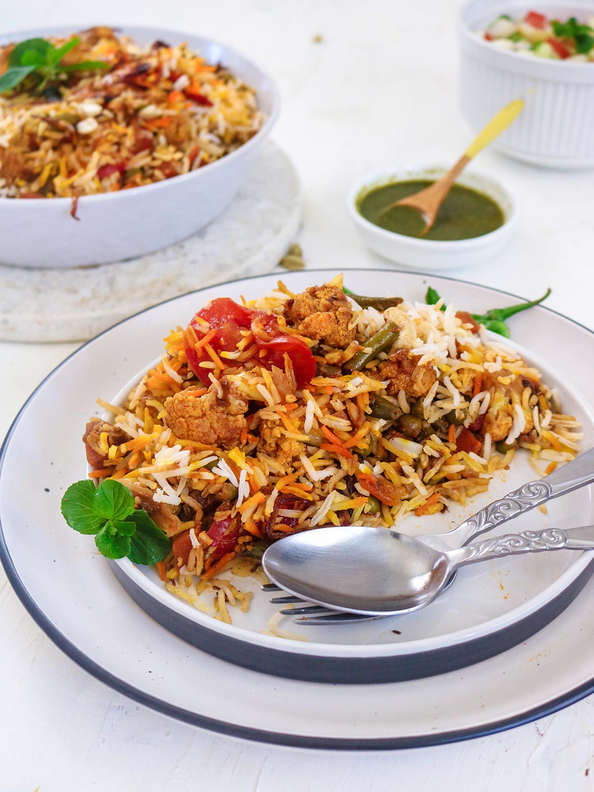 vegan biryani served in a plate with spoon and fork