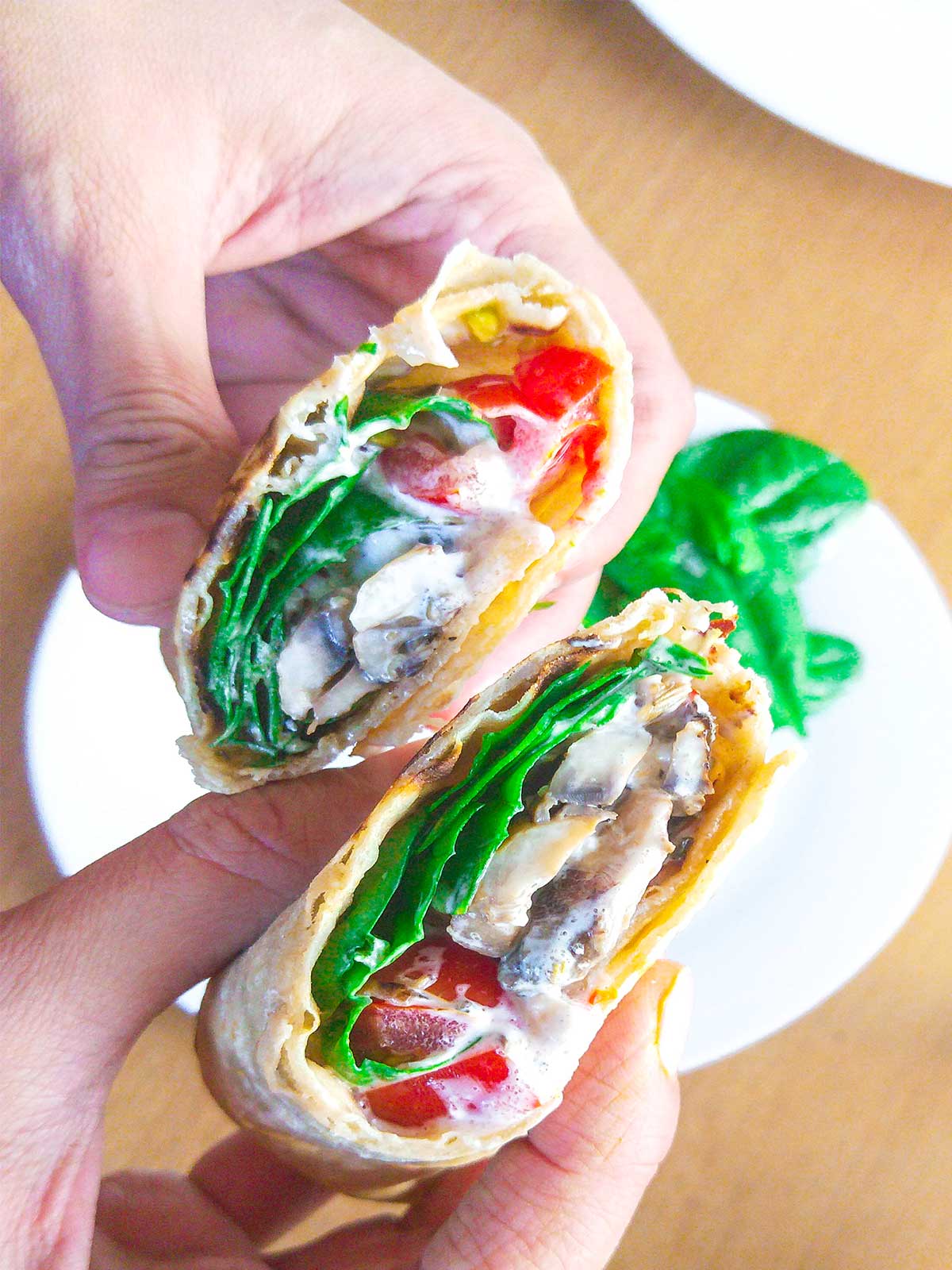 Mushroom wrap cut in half holding in hands