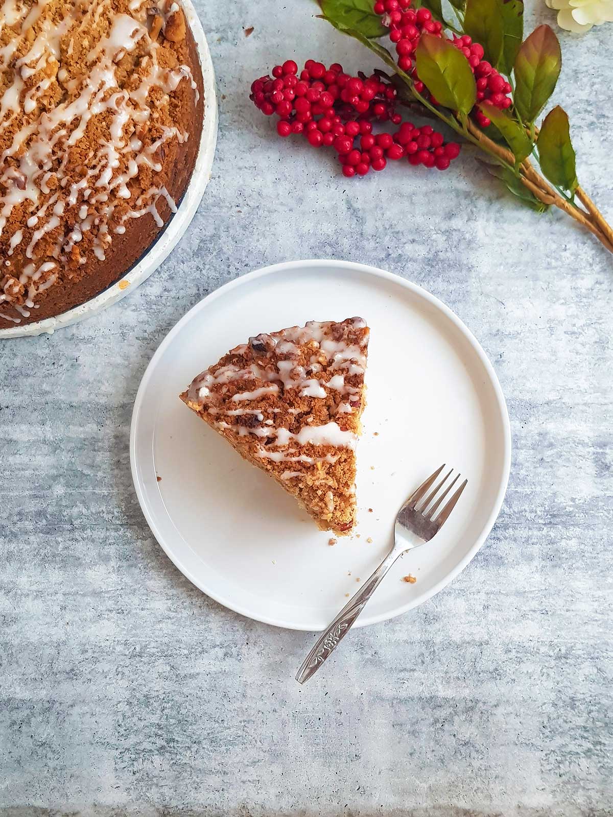 coffee cake slice served in a white plate with fork.