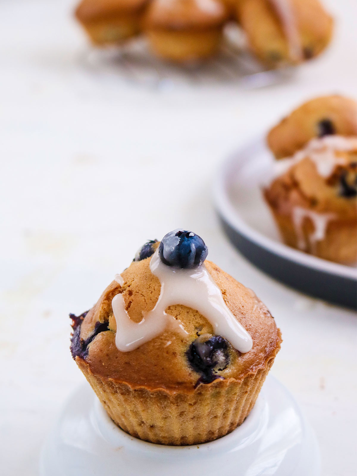 single Vegan Blueberry lemon muffins with glaze on top