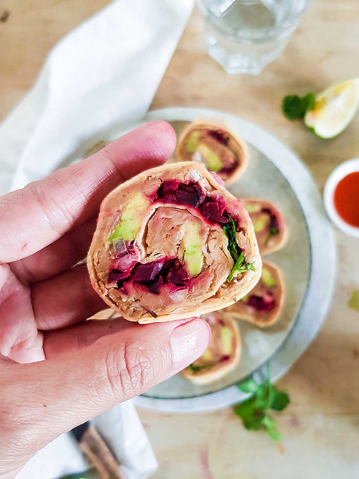 Holding Vegan pinwheels in hand