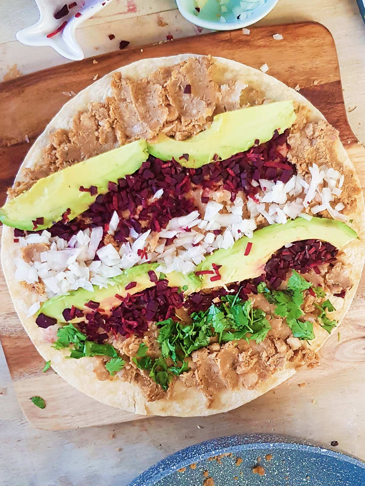 Spreading Toppings on tortilla to make pinwheels