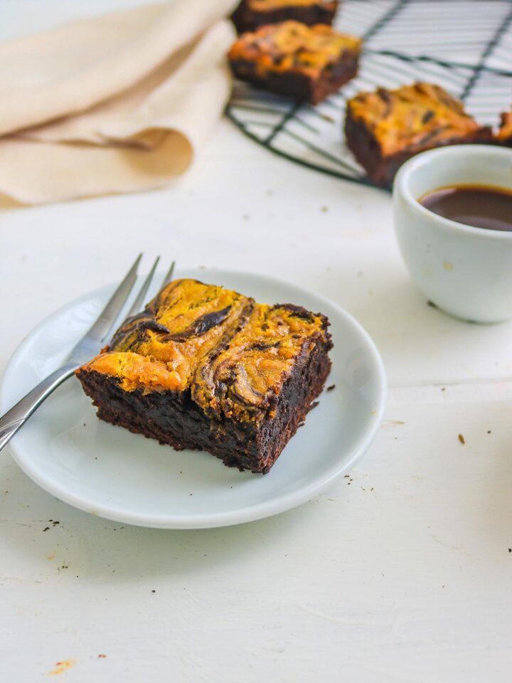 vegan pumpkin brownies served with white plate and fork