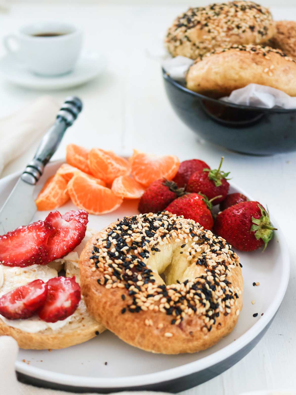 vegan bagel topped with cream cheese and fresh strawberries
