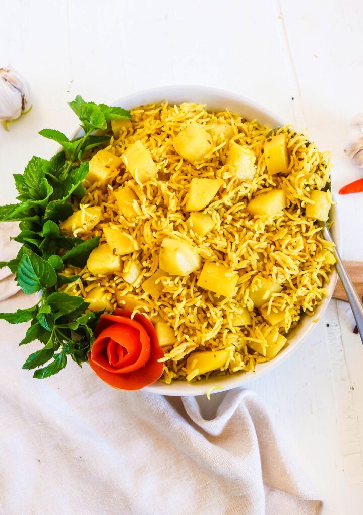 potato and rice served in a bowl with mint leaves 