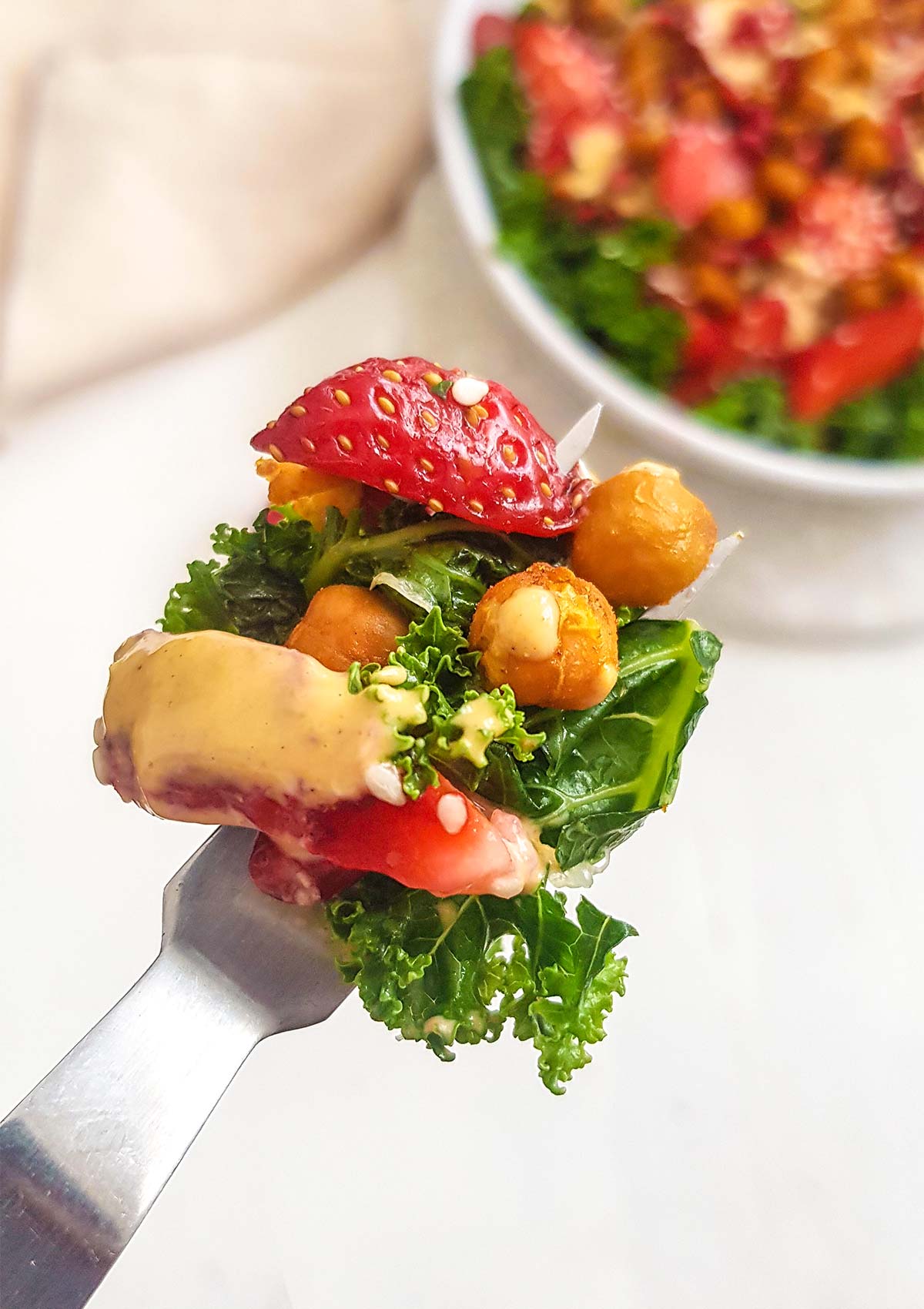 salad bite on fork with tahini dressings