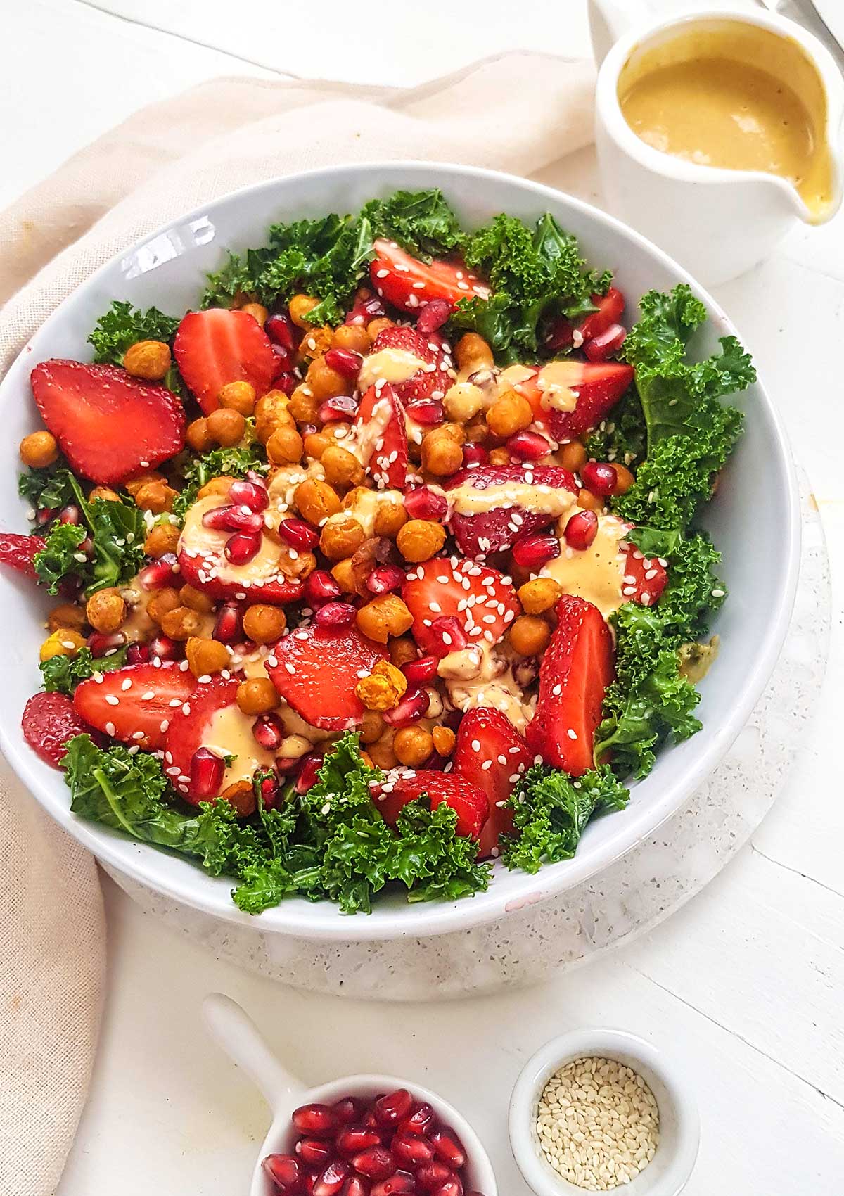 Vegan kale salad topped with tahini dressing