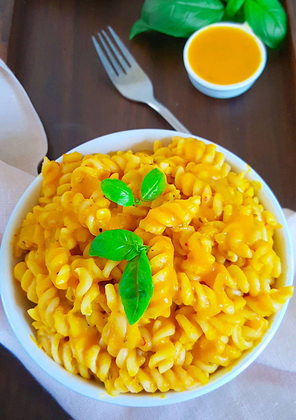 yellow color pumpkin pasta with basil leave on top