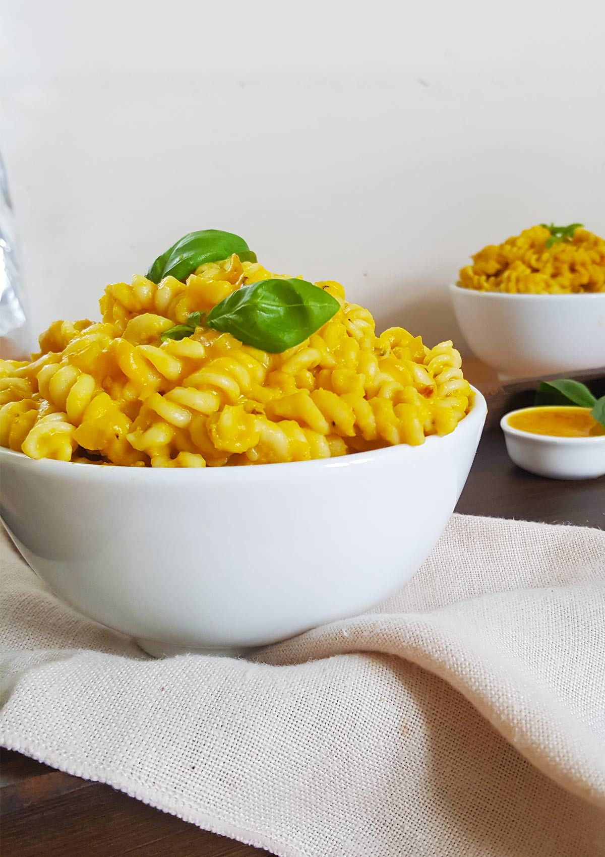 pumpkin pasta served in two white bowls