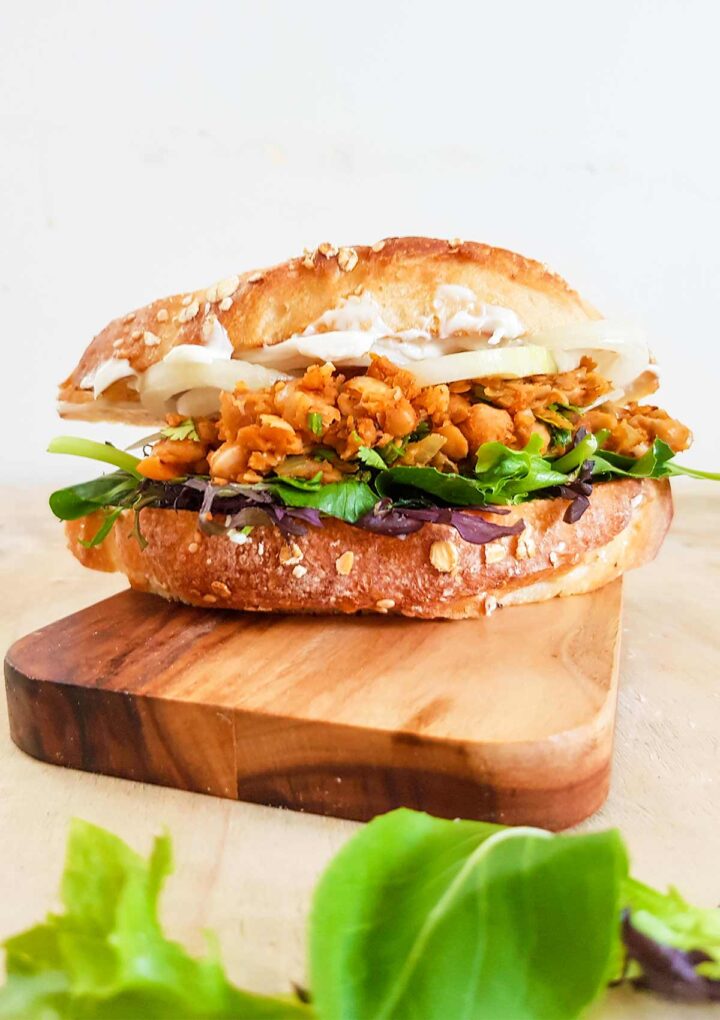 vegan chickpea sandwich placed  on a wooden board