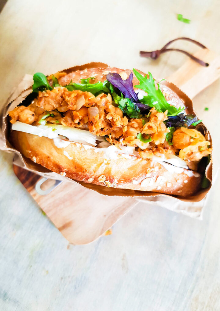 Buffalo chickpea sandwich on a wooden board