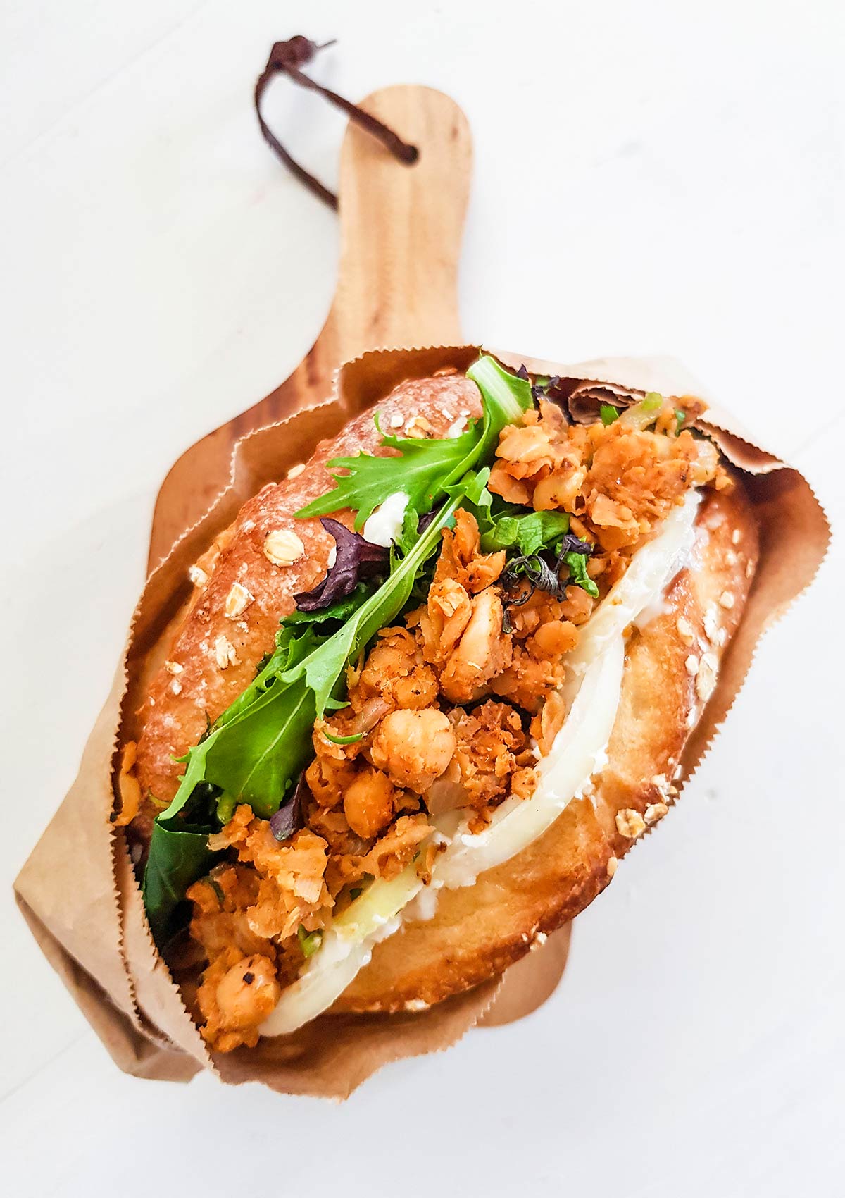 Buffalo chickpea sandwich on a wooden board