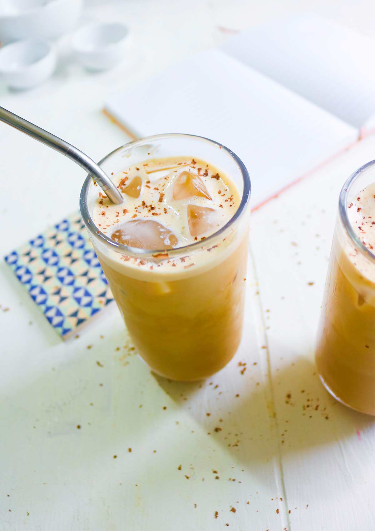 Iced oat milk latter served in two long glasses