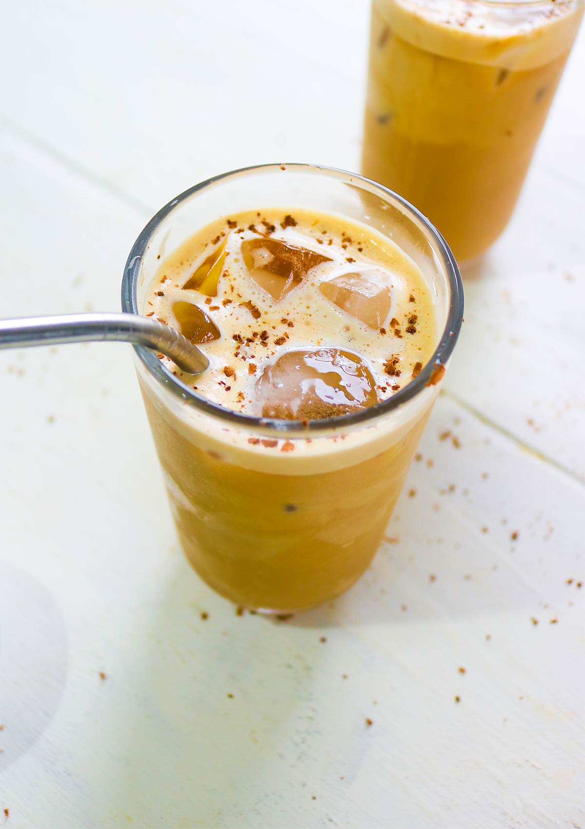 oat milk coffee in a glass with icecubes