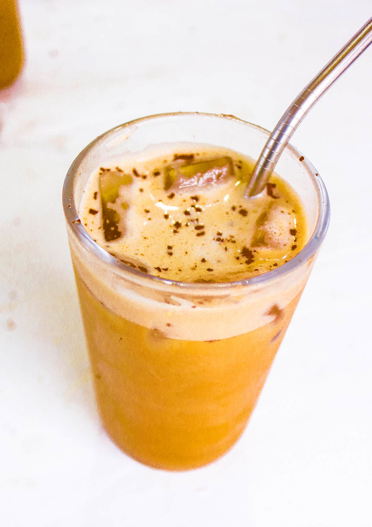 perfect iced coffee made will oat milk in a glass jar