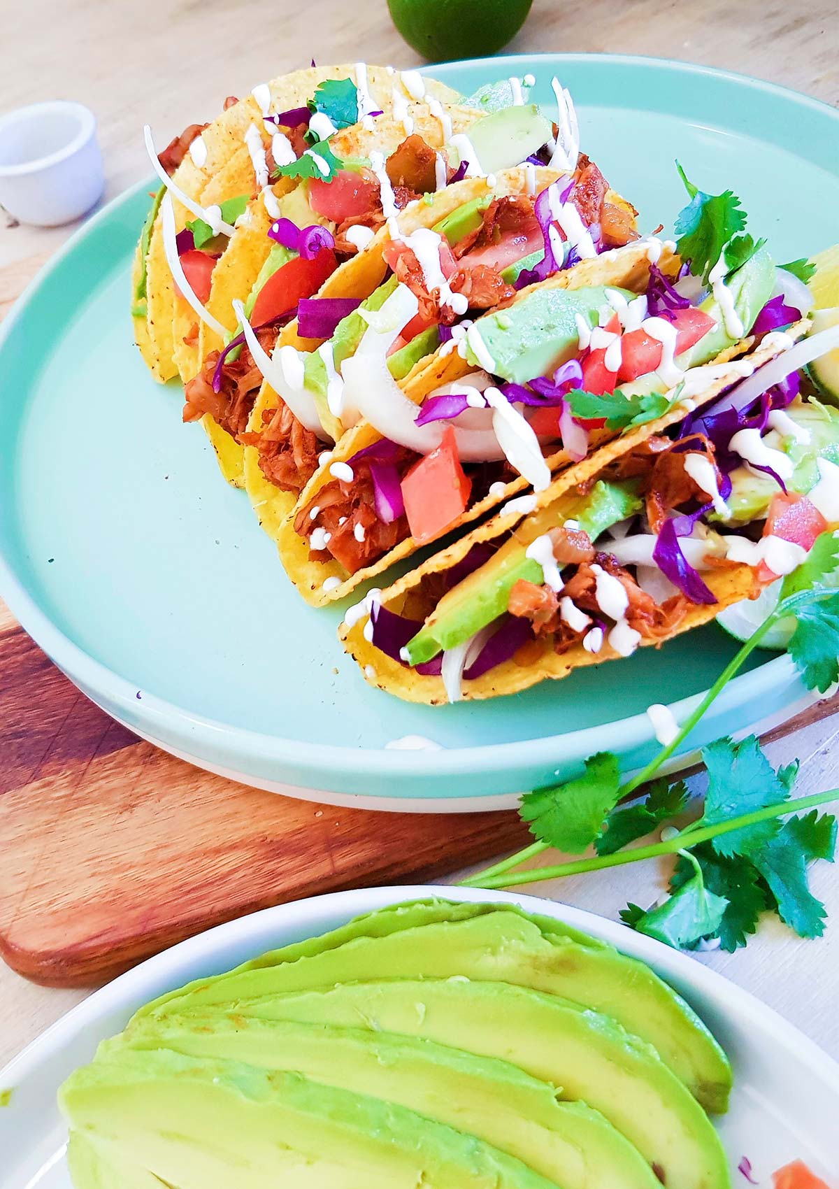 Hard shell tacos filled with jackfruit, avocado,and cabbage.