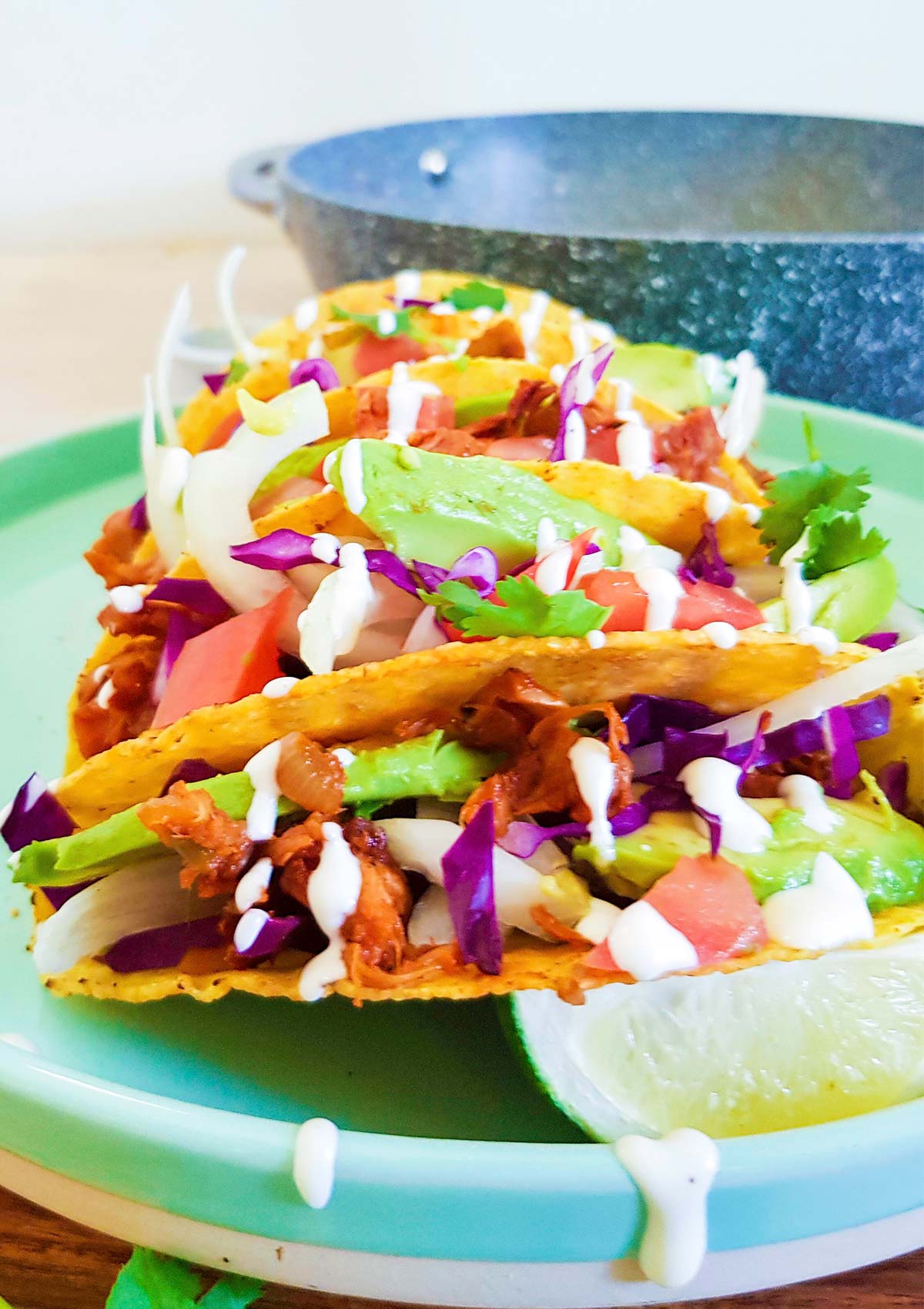 Jackfruit tacos topped with vegan sour cream