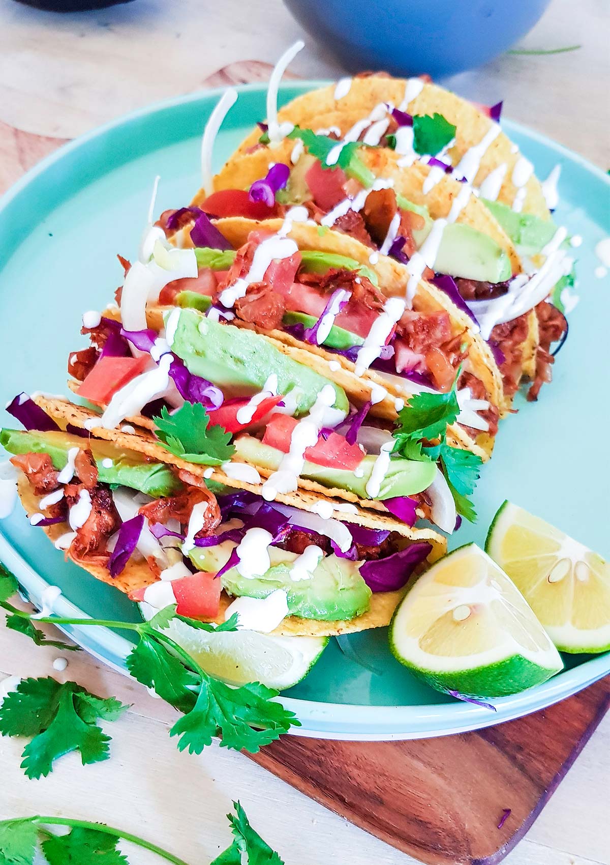 side view of tacos placed in plate with a slice of lime