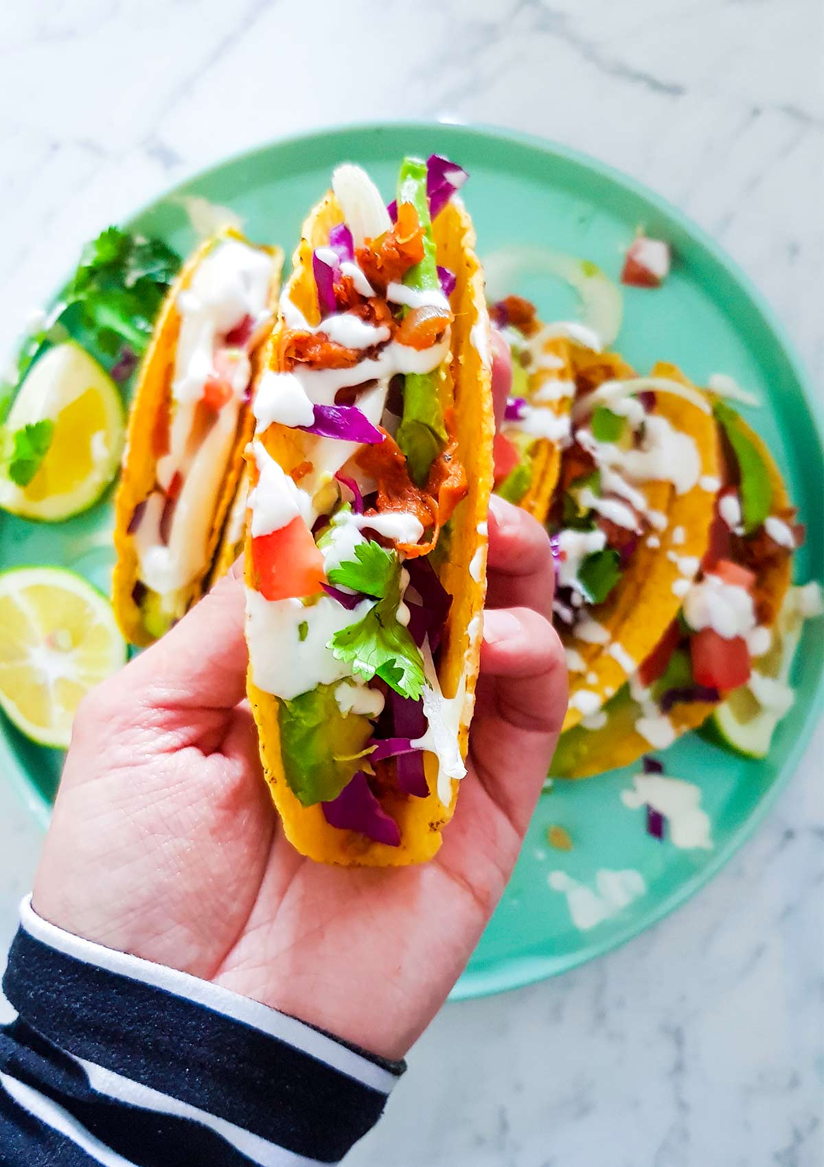 Holding jackfruit taco in hand