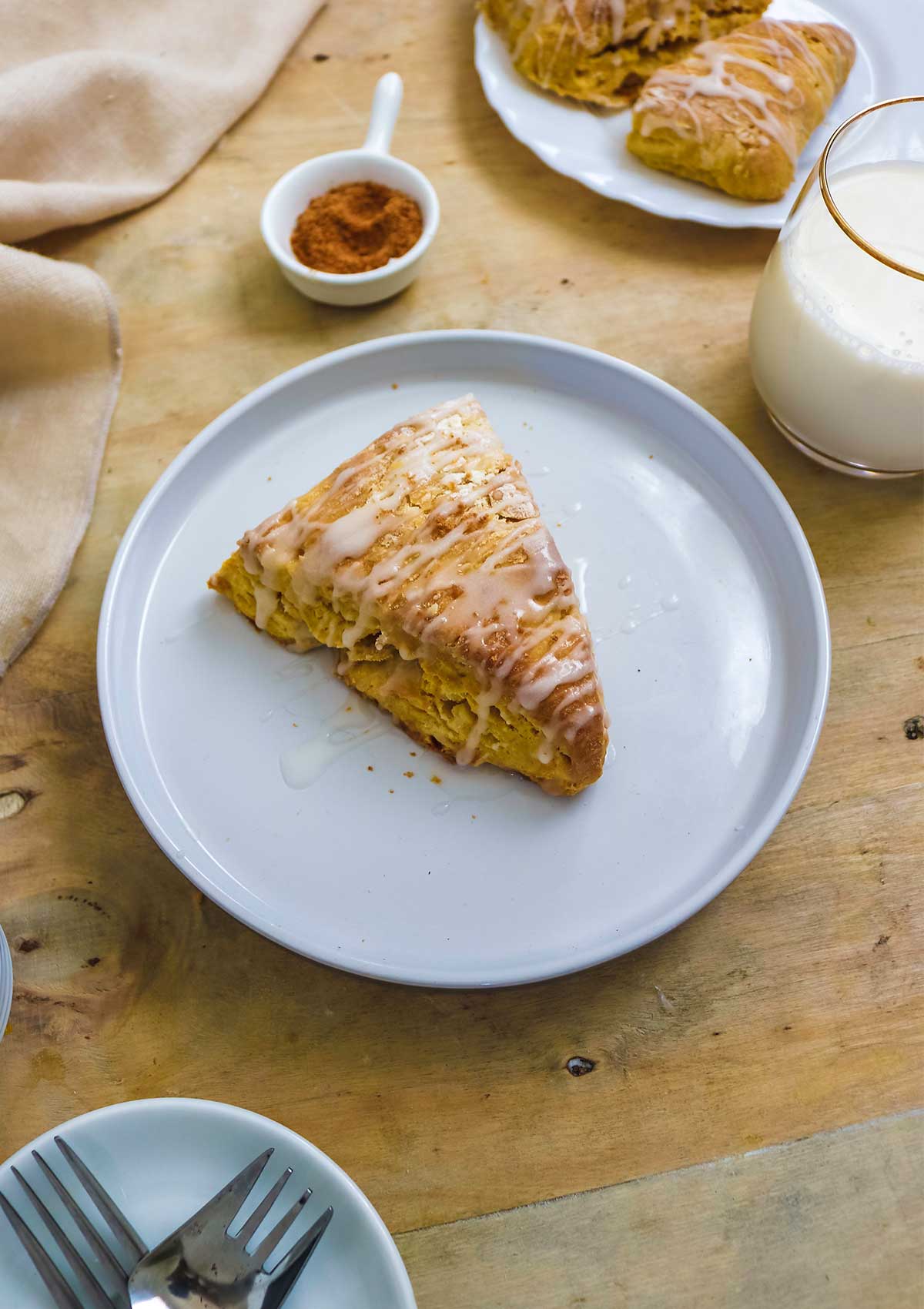 vegan pumpkin scone served with a glass of almond milk
