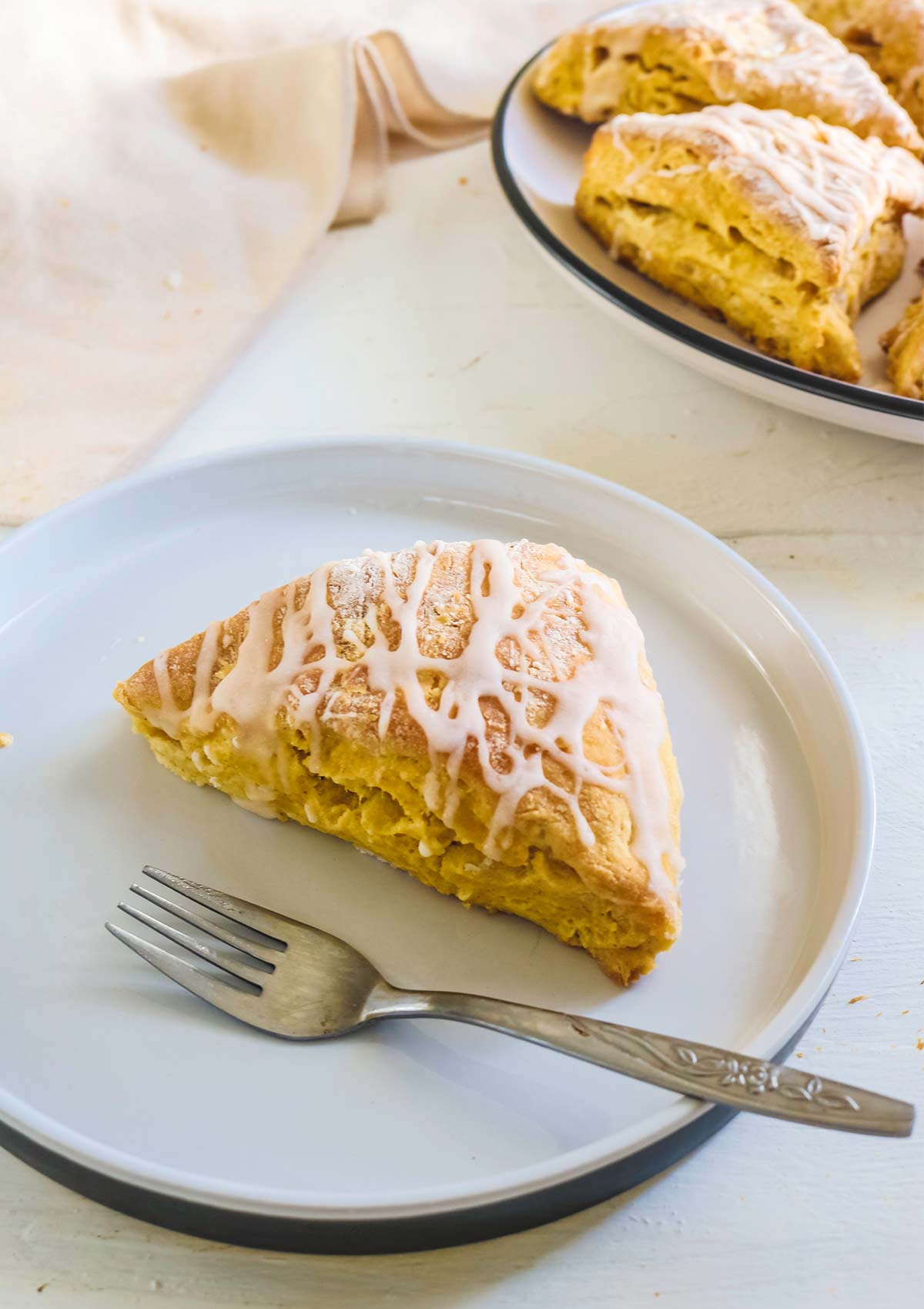 pumpkin scone served in a plate with fork
