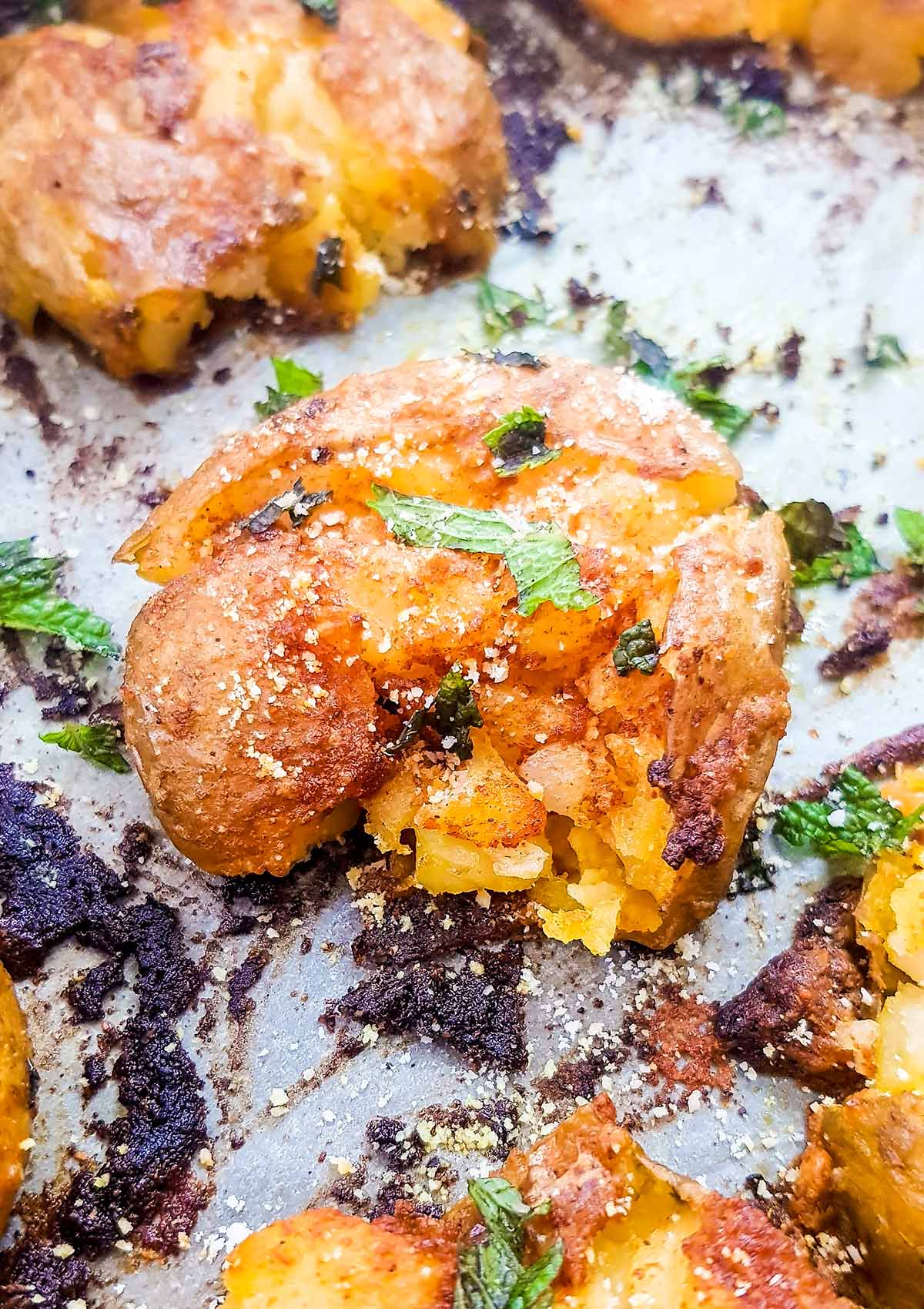 Vegan smashed potatoes in baking tray