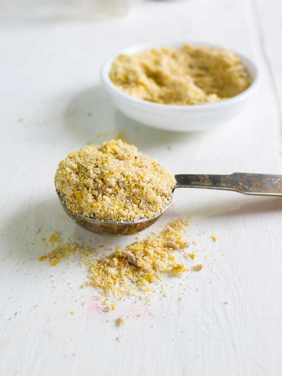 Vegan parmesan cheese in a spoon