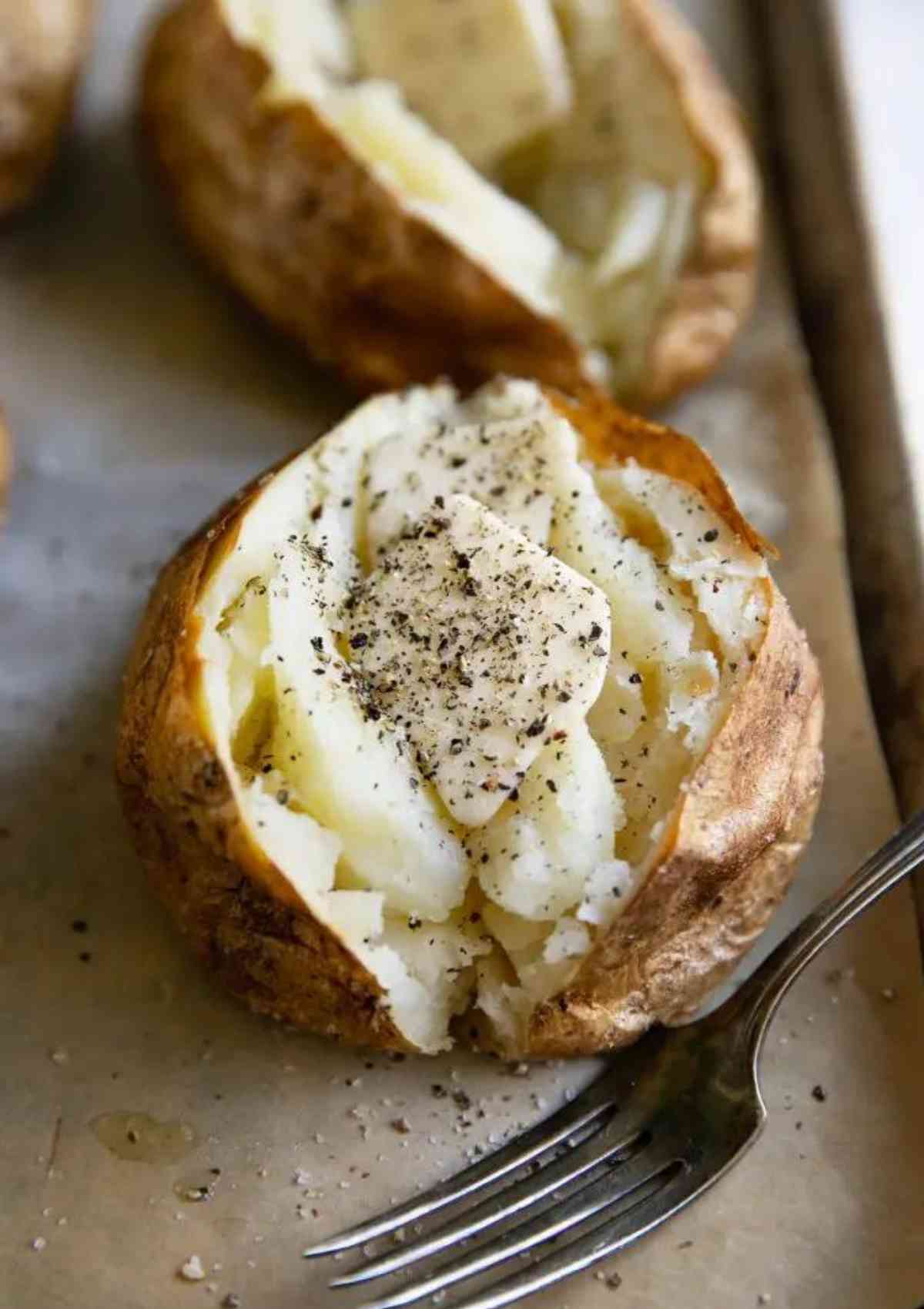 baked potato with a fork on side