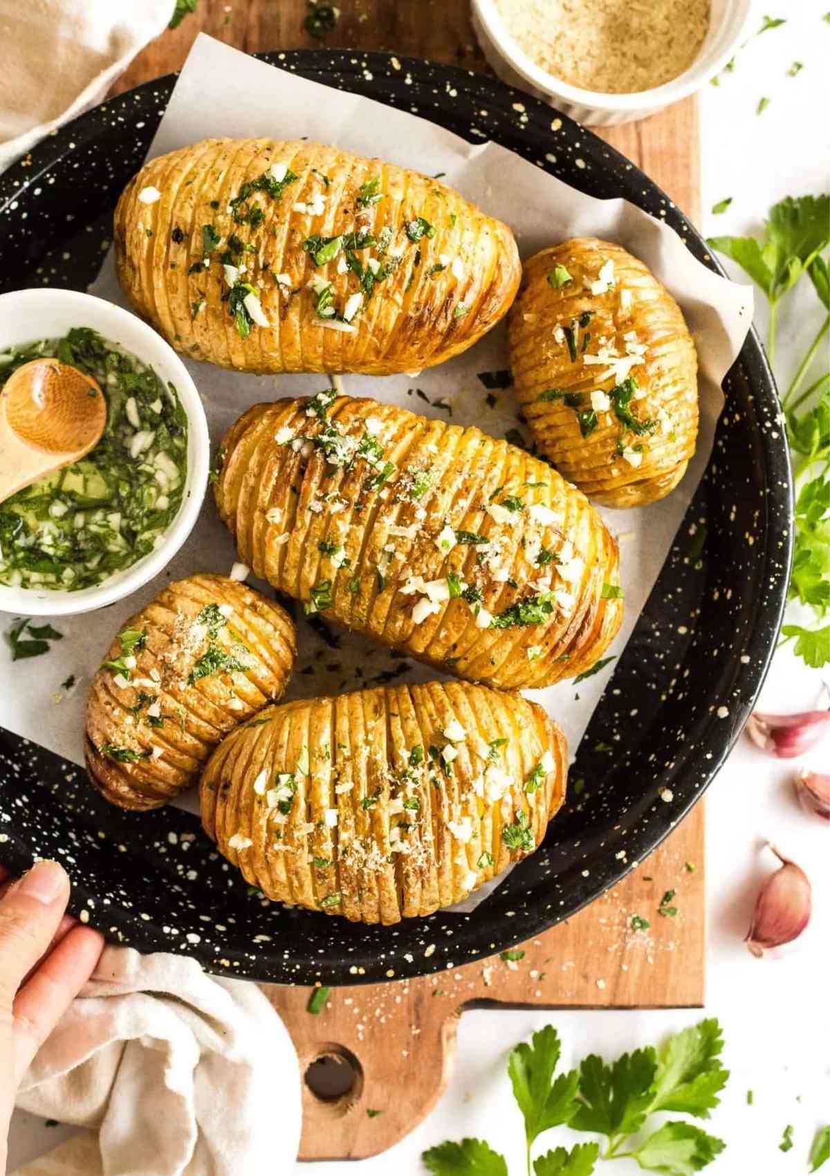 Crispy Hasselback Potatoes served in a black plate 