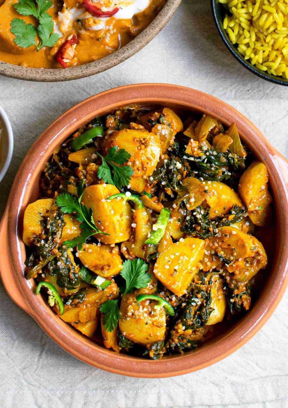 saag aloo served in a brown bowl