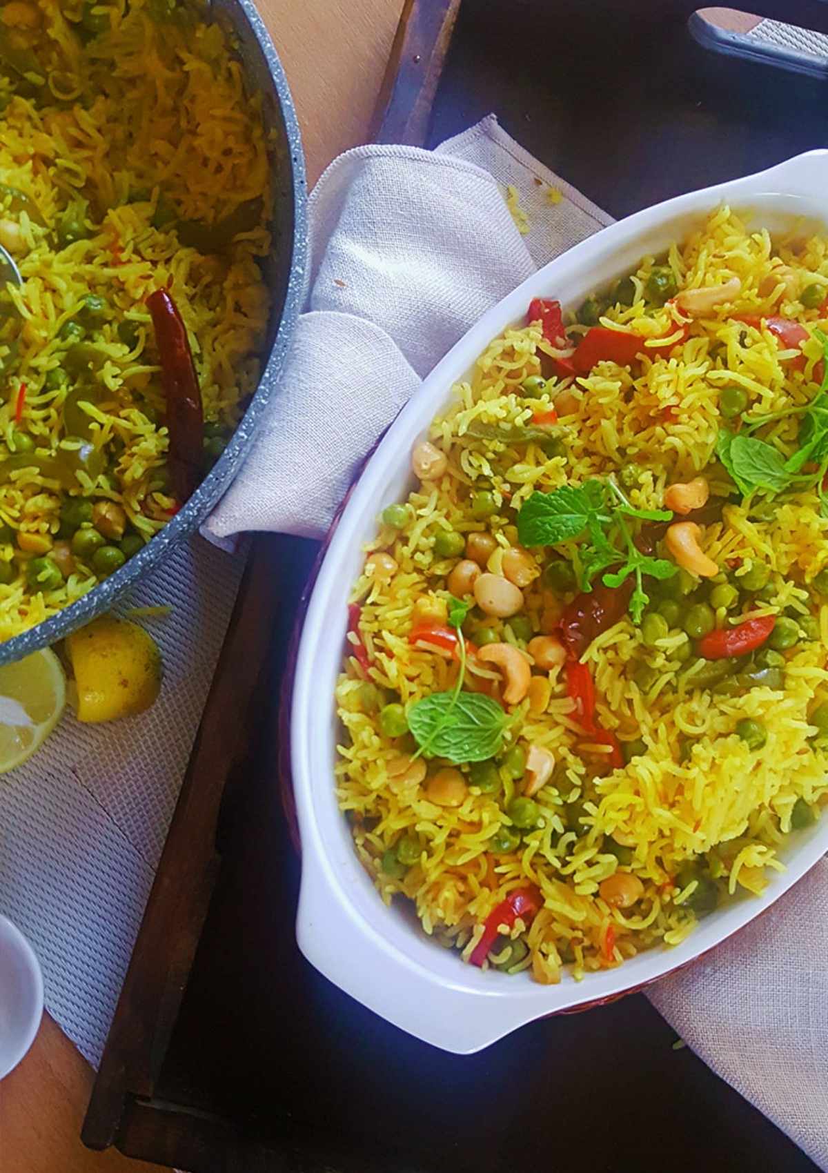 rice served in a white dish and pot on side