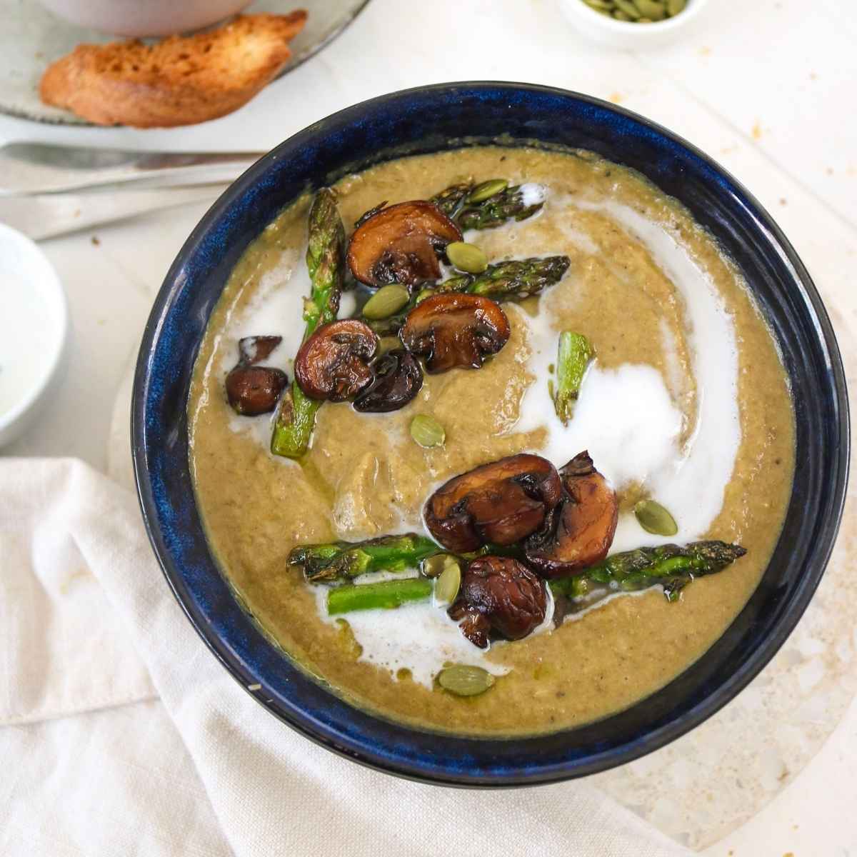 Asparagus and mushroom soup served in a blue bowl