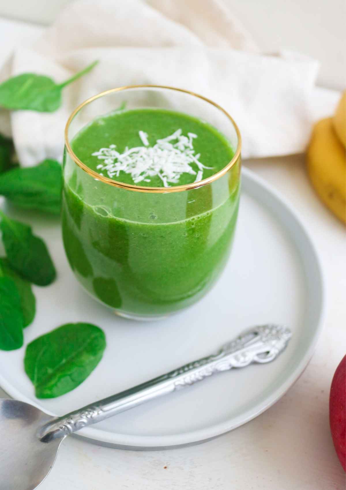 Apple banana spinach topped with coconut flakes