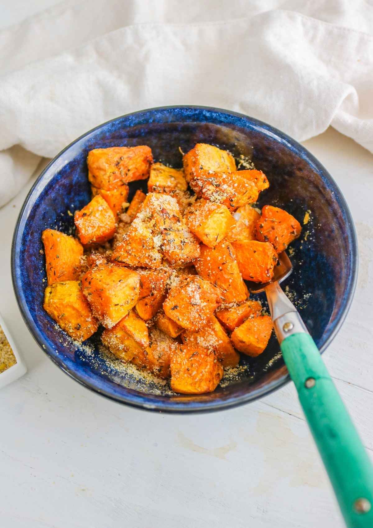 roasted squash cubes  served in a blue color plate.