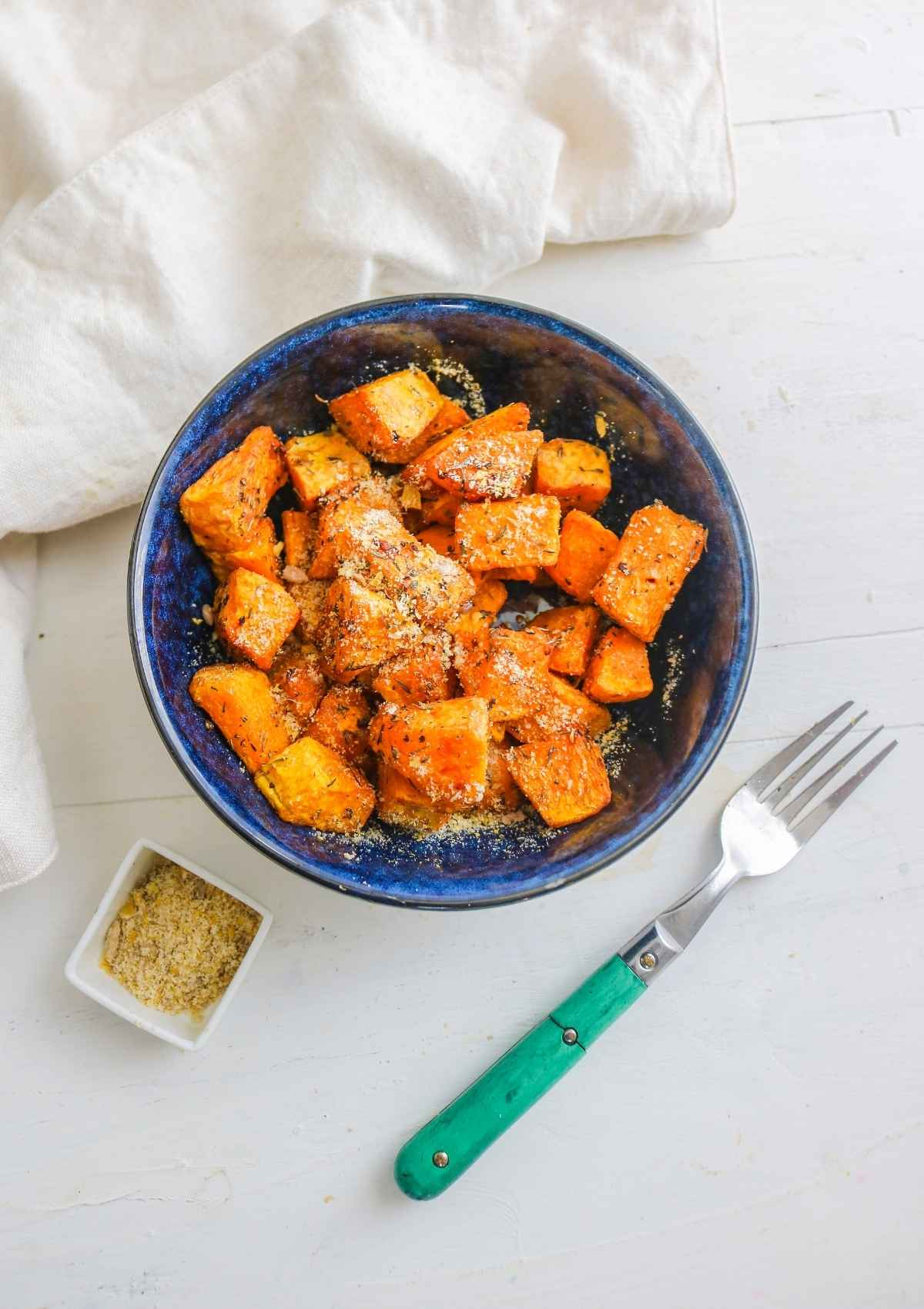 air fryer butternut squash served in a blue bowl.