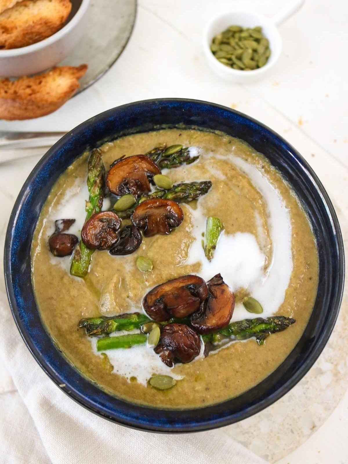 asparagus mushroom soup in a dark bowl