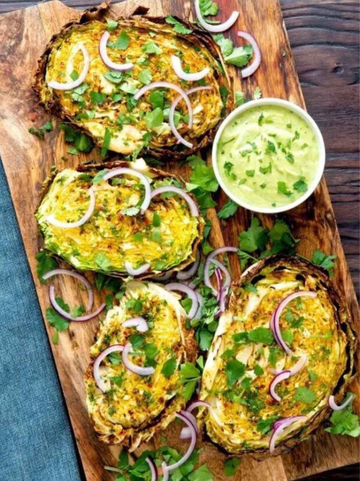 crispy cabbage steaks served on a wooden board