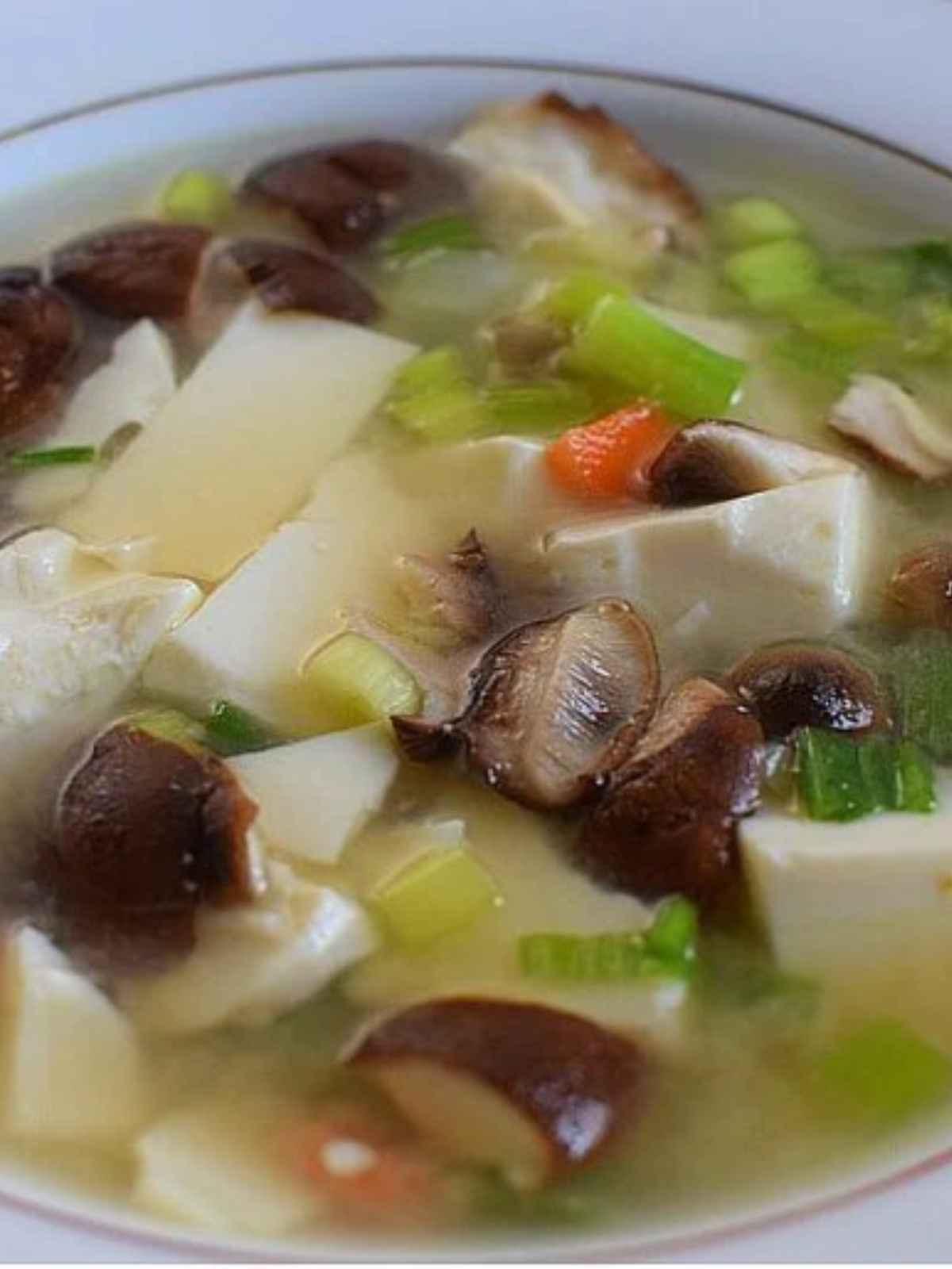 mushroom tofu soup in a glass bowl